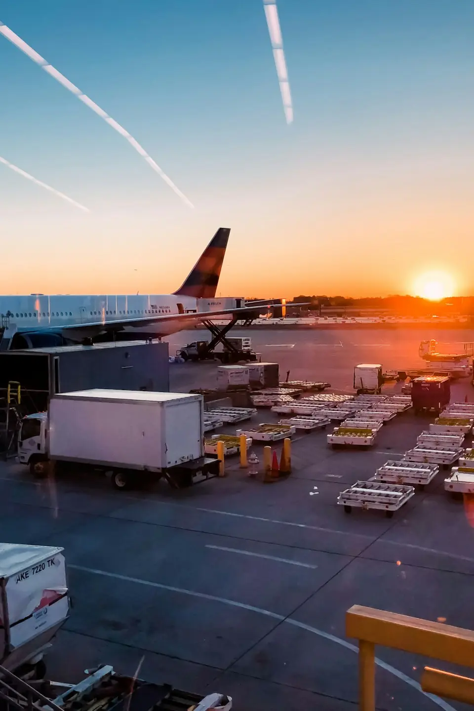 airliner surrounded with vehicles during daytime